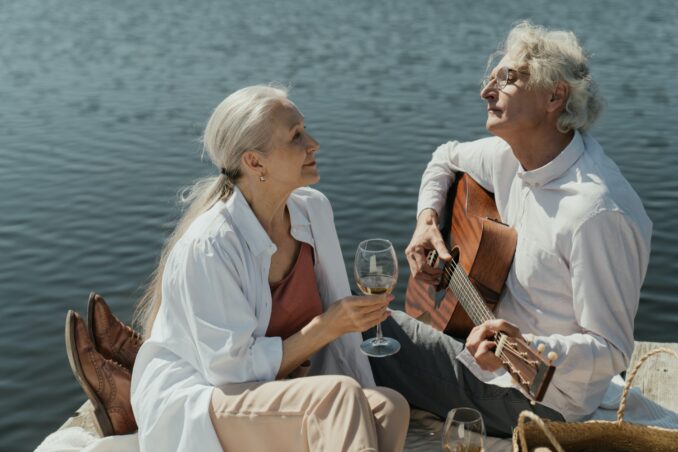Elderly couple sitting by a lake
