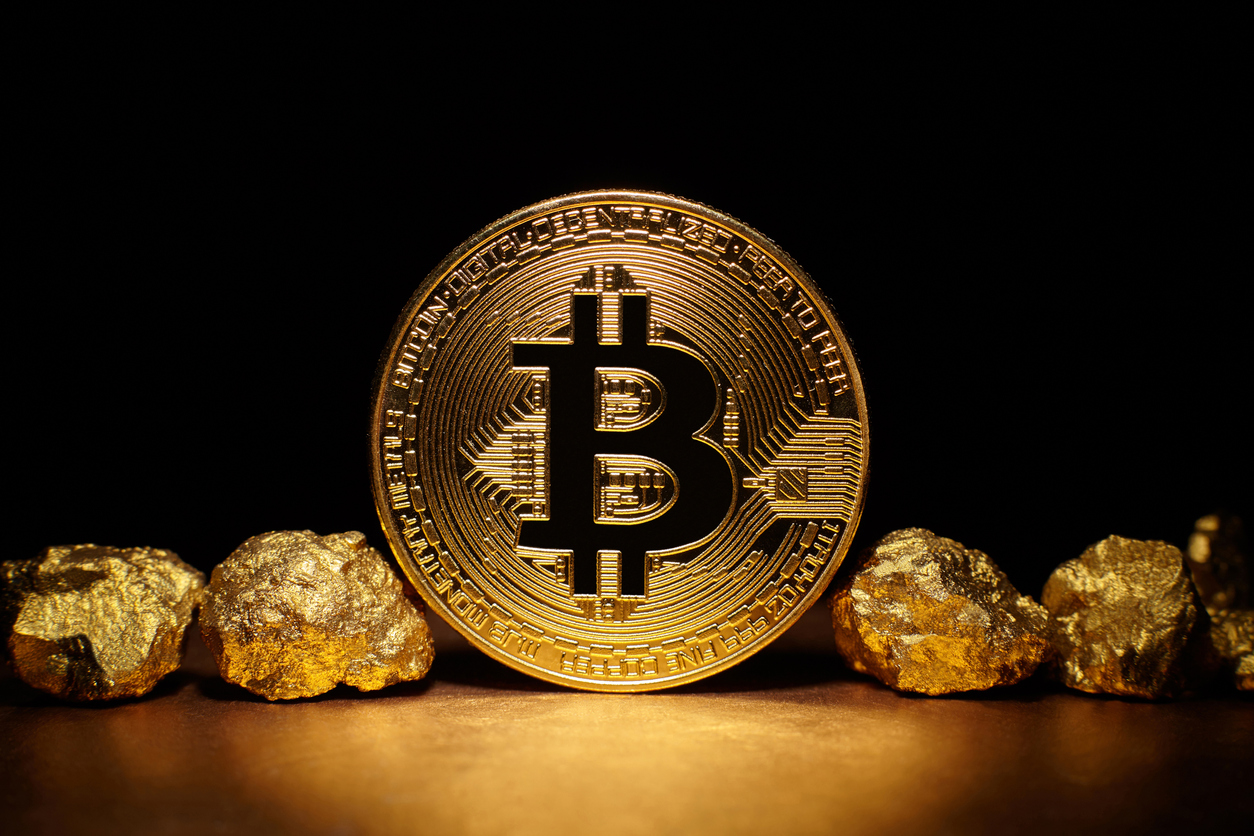 Golden Bitcoin Coin and mound of gold on black background